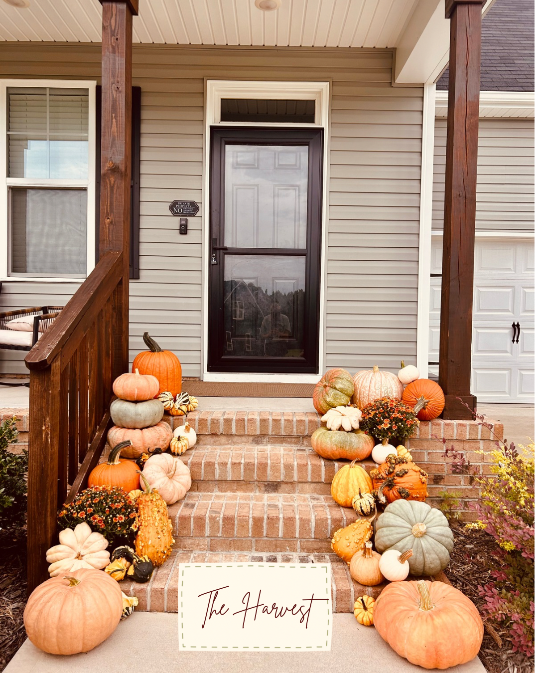 Abundant harvest pumpkin display on brick steps beneath a covered porch